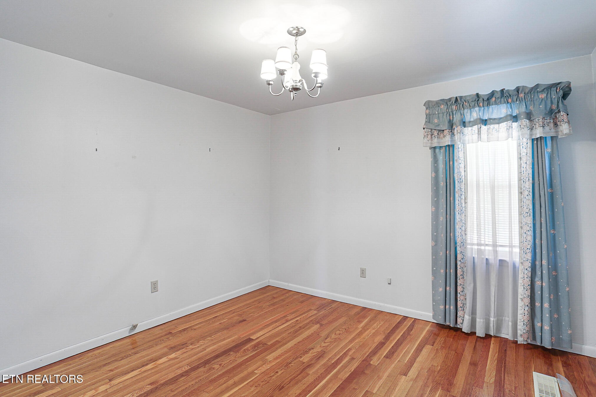 2015 Carolyn Drive Jefferson City, TN 37760 - Photo 25 of 44 a view of a room with wooden floor a ceiling fan and windows