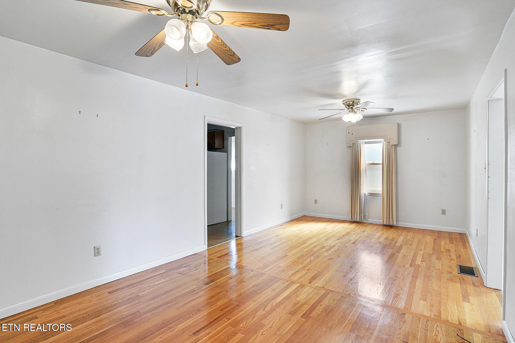 2015 Carolyn Drive Jefferson City, TN 37760 - Photo 7 of 44 a view of an empty room with wooden floor and a chandelier fan