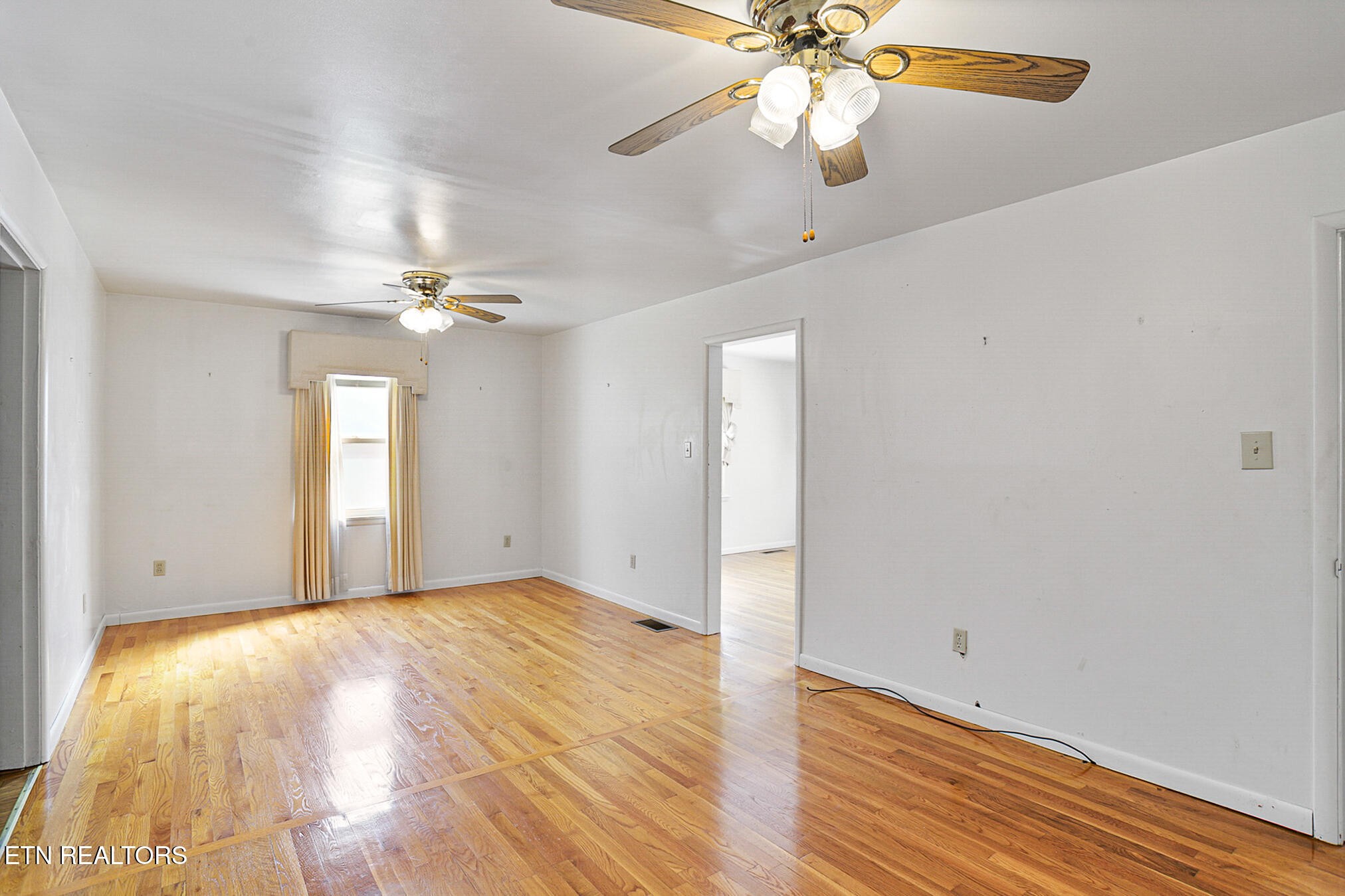 2015 Carolyn Drive Jefferson City, TN 37760 - Photo 8 of 44 an empty room with wooden floor fan and windows