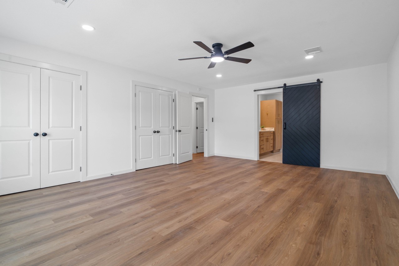 5326 Findlay Drive Pasadena, TX 77505 - Photo 31 of 50 Spacious primary retreat features ample room for a sitting area, multiple closets, and a stylish barn door leading to the luxurious ensuite bath.