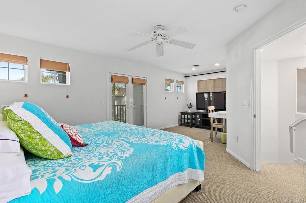7039 Whitewater Street Carlsbad, CA 92011 - Photo 15 of 65 a bedroom with a bed and a chandelier