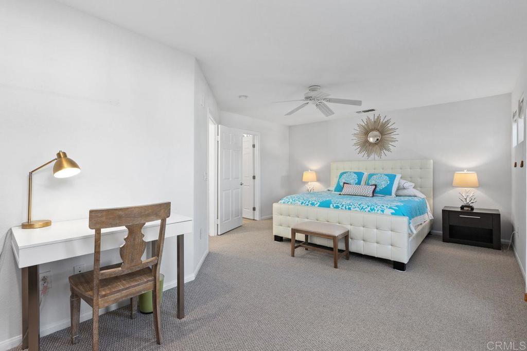 7039 Whitewater Street Carlsbad, CA 92011 - Photo 17 of 65 a bedroom with a bed and a table