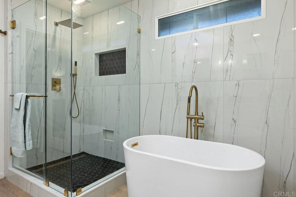 7039 Whitewater Street Carlsbad, CA 92011 - Photo 20 of 65 a bathroom with a tub a toilet and a shower