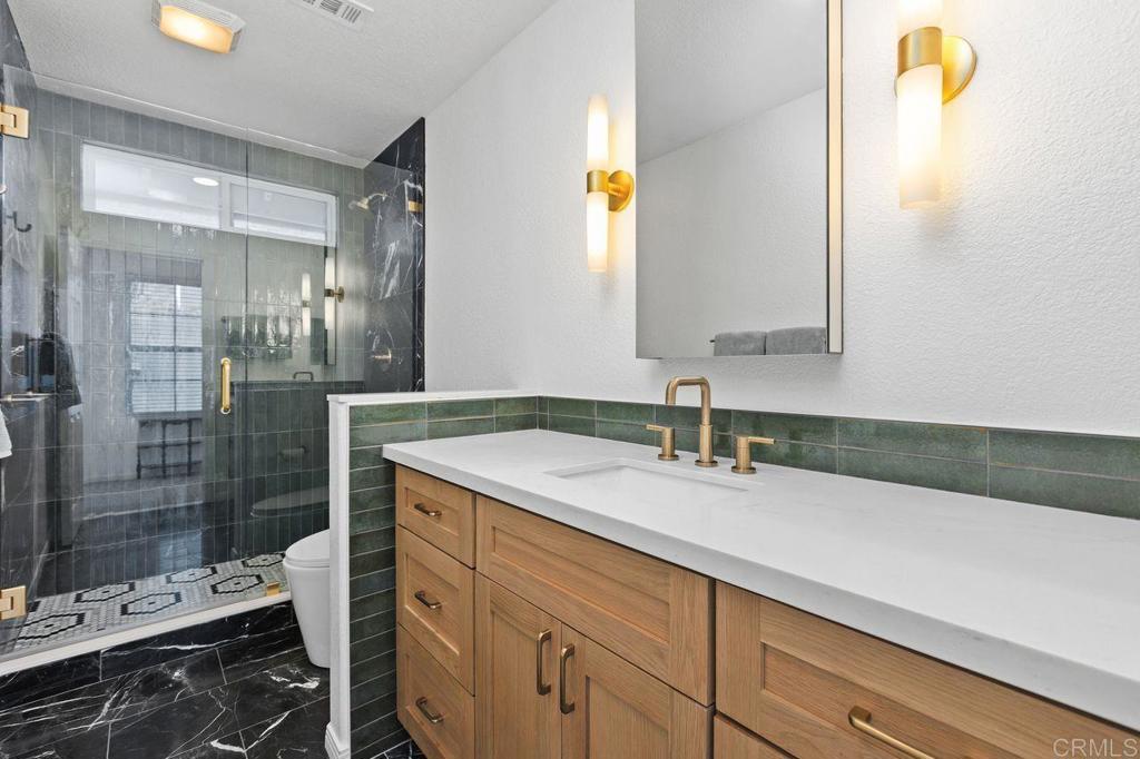 7039 Whitewater Street Carlsbad, CA 92011 - Photo 26 of 65 a bathroom with a sink and a mirror