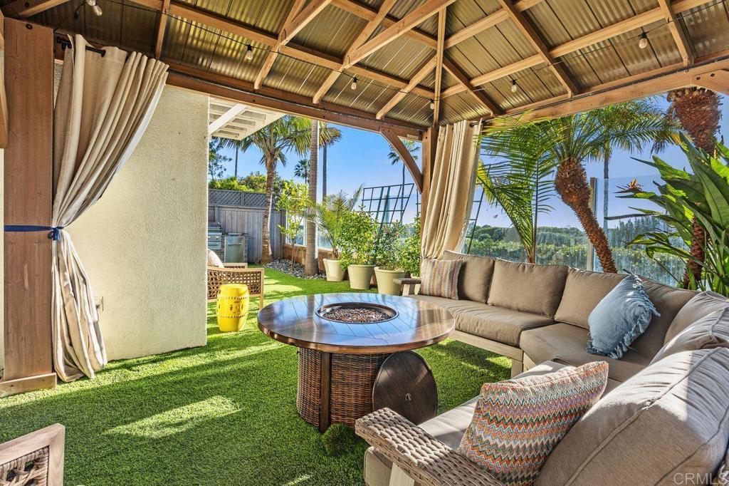 7039 Whitewater Street Carlsbad, CA 92011 - Photo 34 of 65 a backyard of a house with table and chairs
