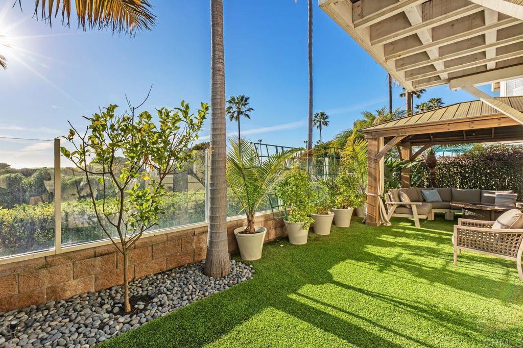 7039 Whitewater Street Carlsbad, CA 92011 - Photo 39 of 65 a view of a patio with table and chairs potted plants