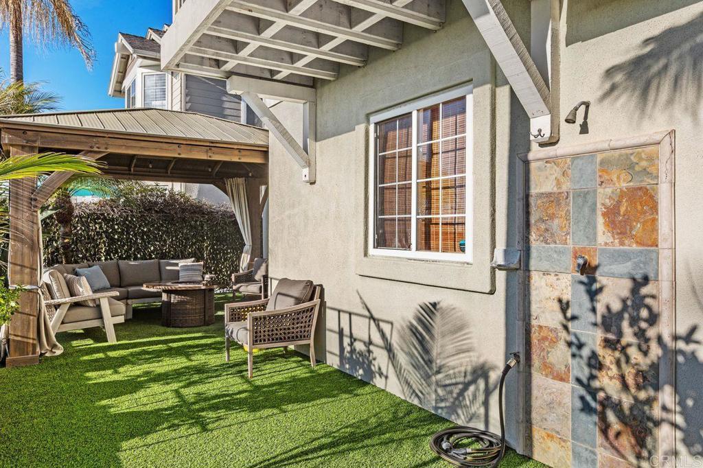 7039 Whitewater Street Carlsbad, CA 92011 - Photo 40 of 65 a view of a porch with chairs and potted plants