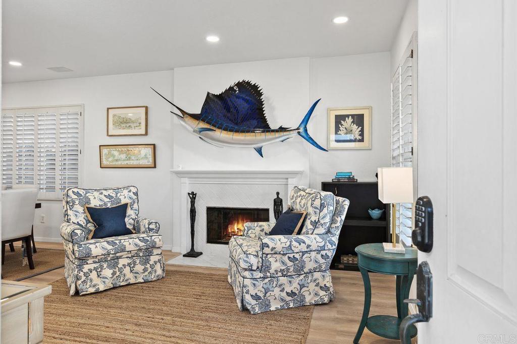7039 Whitewater Street Carlsbad, CA 92011 - Photo 59 of 65 a living room with furniture and a fireplace