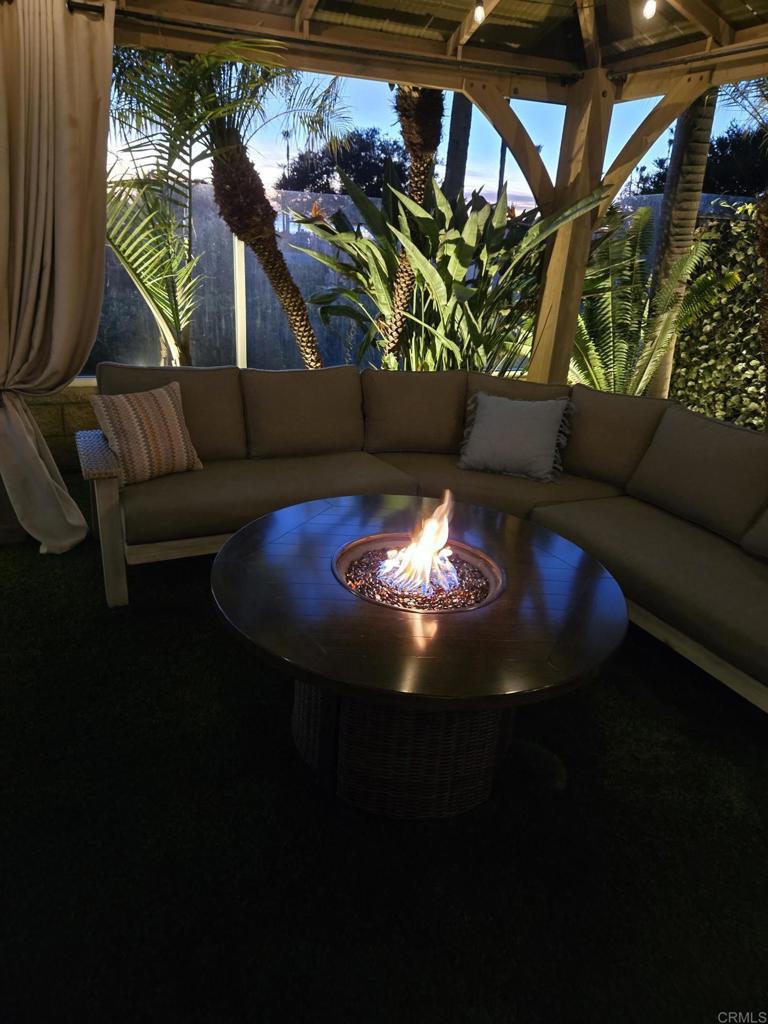 7039 Whitewater Street Carlsbad, CA 92011 - Photo 65 of 65 a living room with furniture and a fireplace