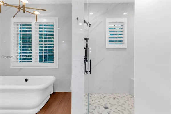 a bathroom with a bathtub and a shower