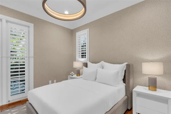 a bedroom with a bed and a lamp