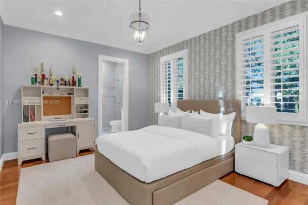 a bedroom with a large bed and a window