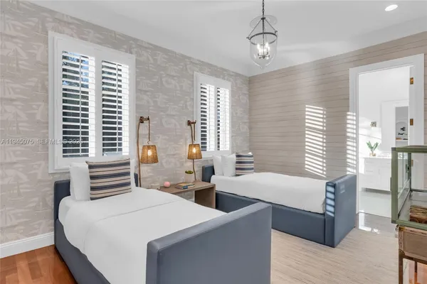 a bedroom with a bed and a chandelier