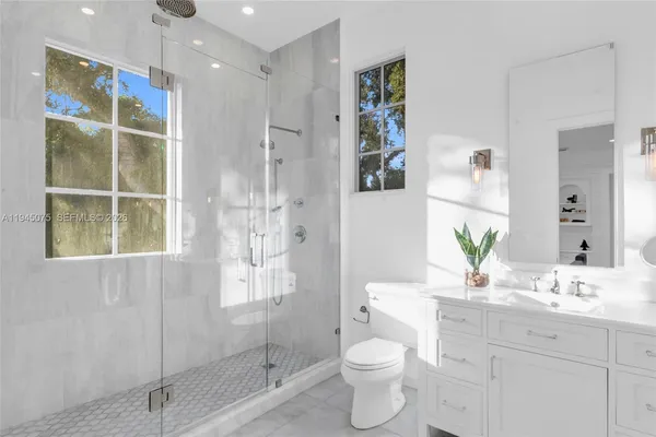 a bathroom with a toilet sink and shower