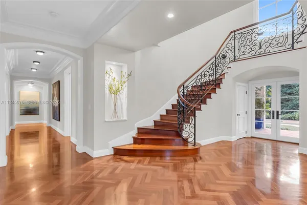 a view of entryway and hall with wooden floor