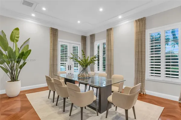 a view of a dining room with furniture and a potted plant