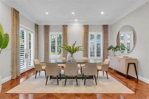 a dining room with furniture and wooden floor
