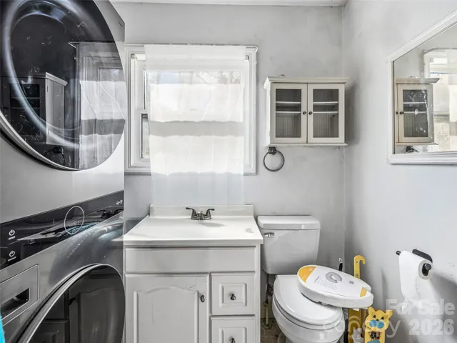 a bathroom with a sink a toilet and a mirror