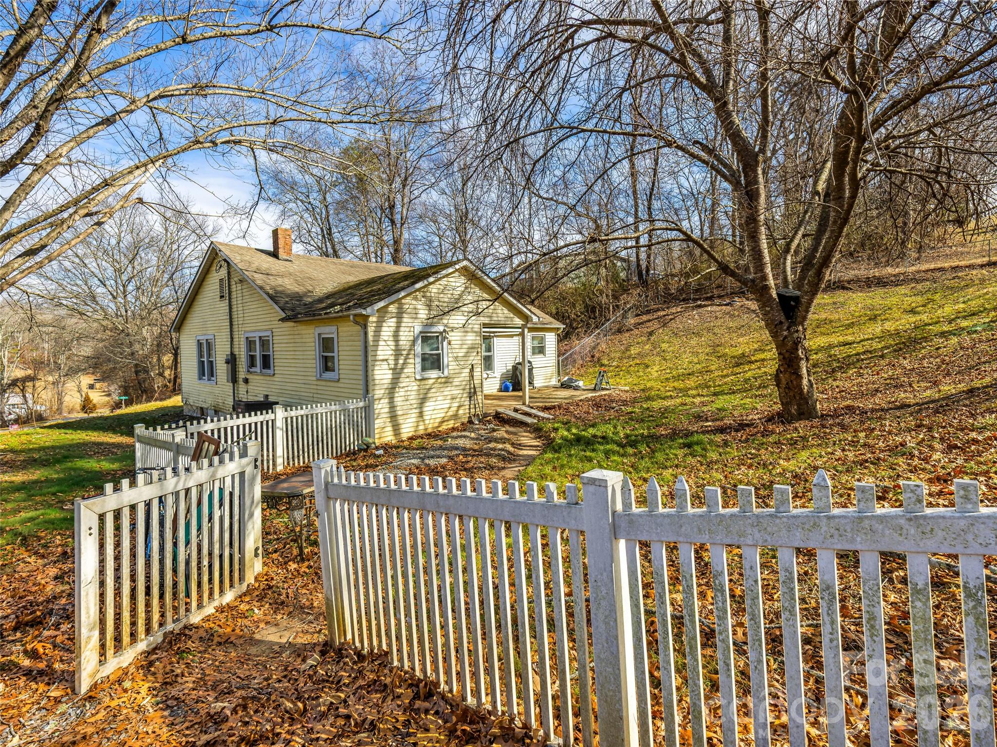 800 Murray Road Canton, NC 28716 - Photo 15 of 15 a view of a house with a small yard and wooden fence