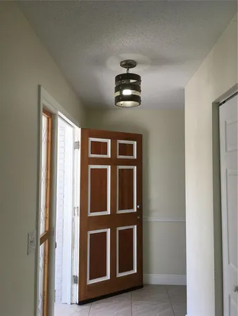 a view of a room with an empty space and a window