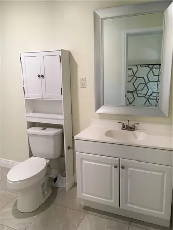 a white toilet sitting next to a bathroom sink