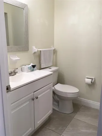 a bathroom with a toilet and a mirror