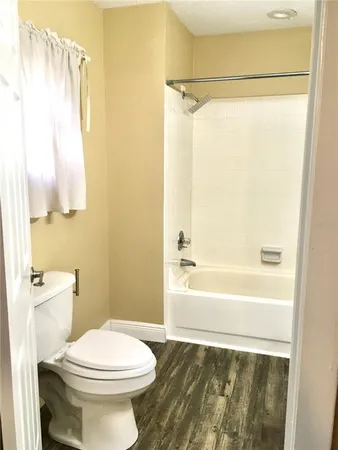 a view of a patio with a table and chairs under an umbrella
