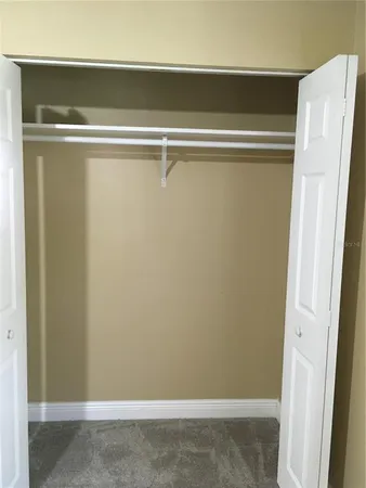 a view of walk in closet and window