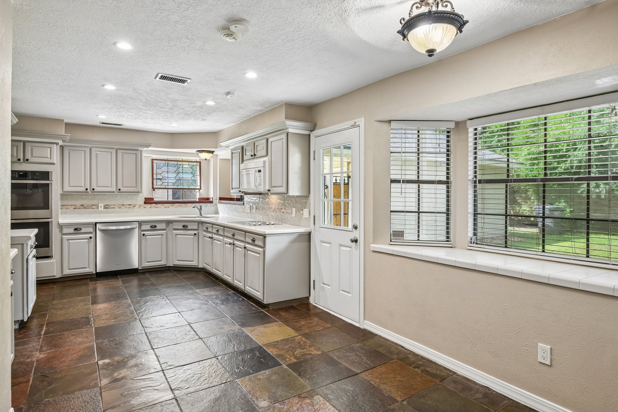 17703 Oaksham Lane Spring, TX 77379 - Photo 11 of 46 Eat In Kitchen with Quartz Counters and Slate Flooring