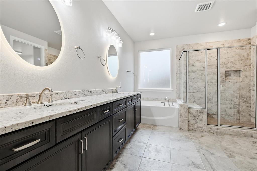 8813 Basanite Avenue Denton, TX 76207 - Photo 18 of 40 a spacious bathroom with a double vanity sink mirror double and bathtub
