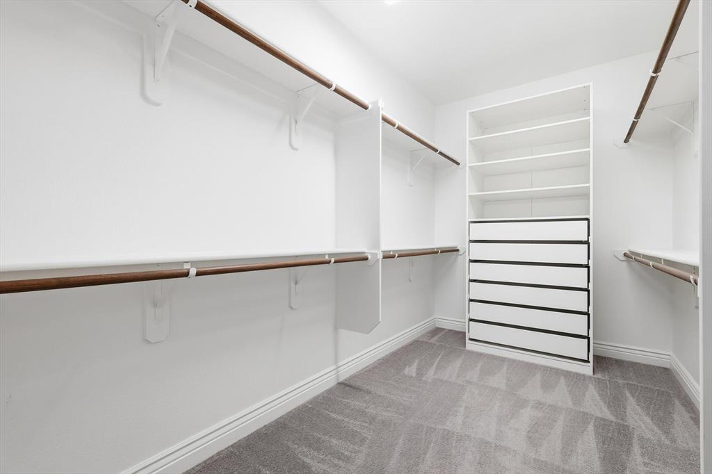 8813 Basanite Avenue Denton, TX 76207 - Photo 22 of 40 a view of walk in closet with empty racks