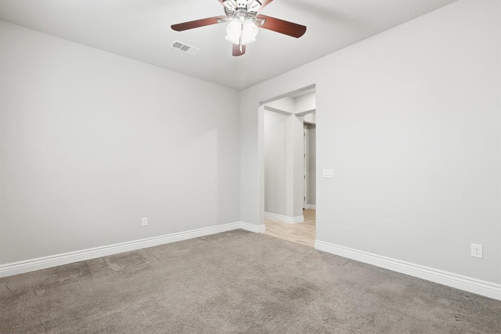 8813 Basanite Avenue Denton, TX 76207 - Photo 24 of 40 an empty room with chandelier fan