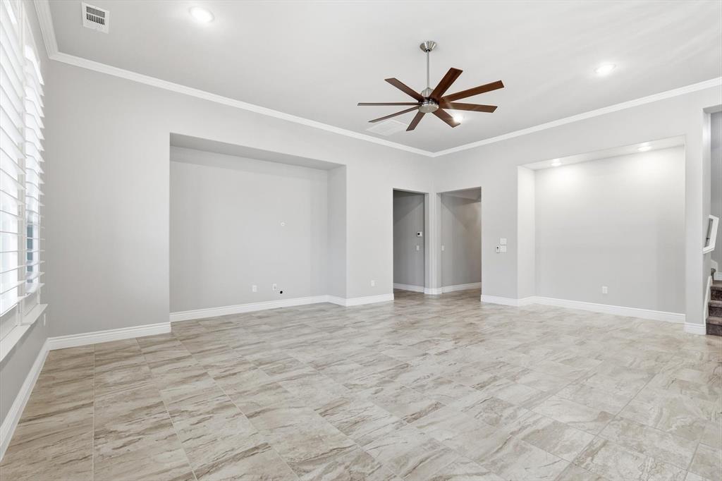 8813 Basanite Avenue Denton, TX 76207 - Photo 3 of 40 a view of an empty room with window and a ceiling fan