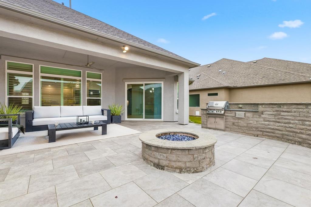 8813 Basanite Avenue Denton, TX 76207 - Photo 8 of 40 a view of a patio with a table and chairs and potted plants