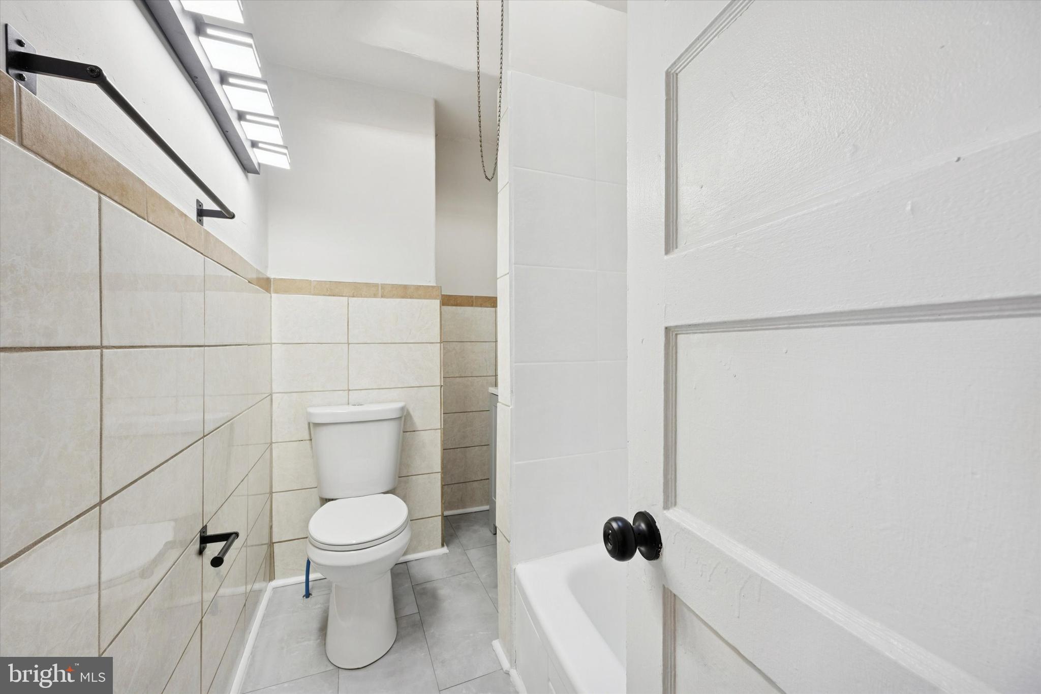 2537 South Millick Street Philadelphia, PA 19142 - Photo 12 of 15 a white toilet sitting next to a shower