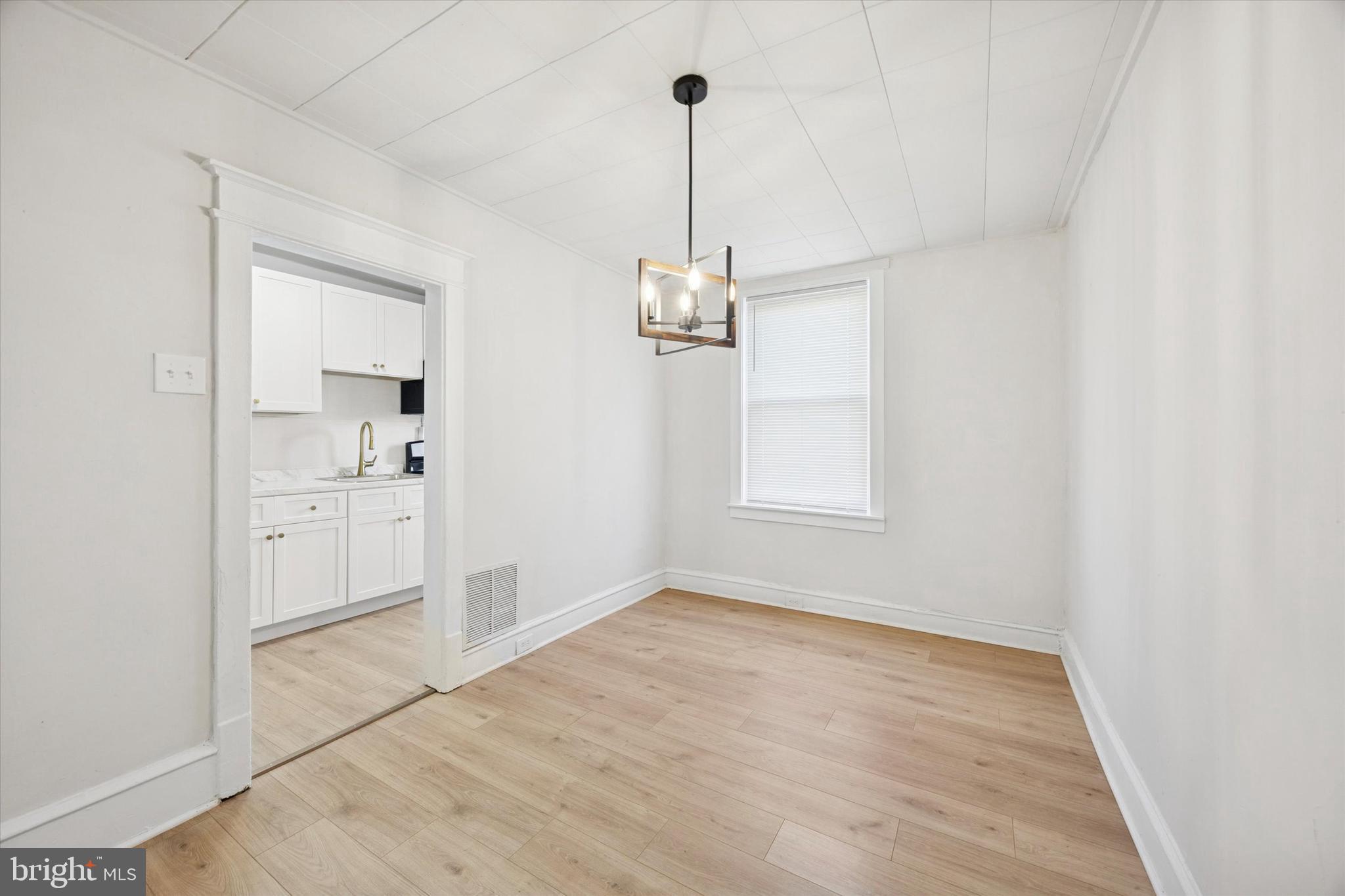 2537 South Millick Street Philadelphia, PA 19142 - Photo 5 of 15 a view of a kitchen with wooden floor and a window