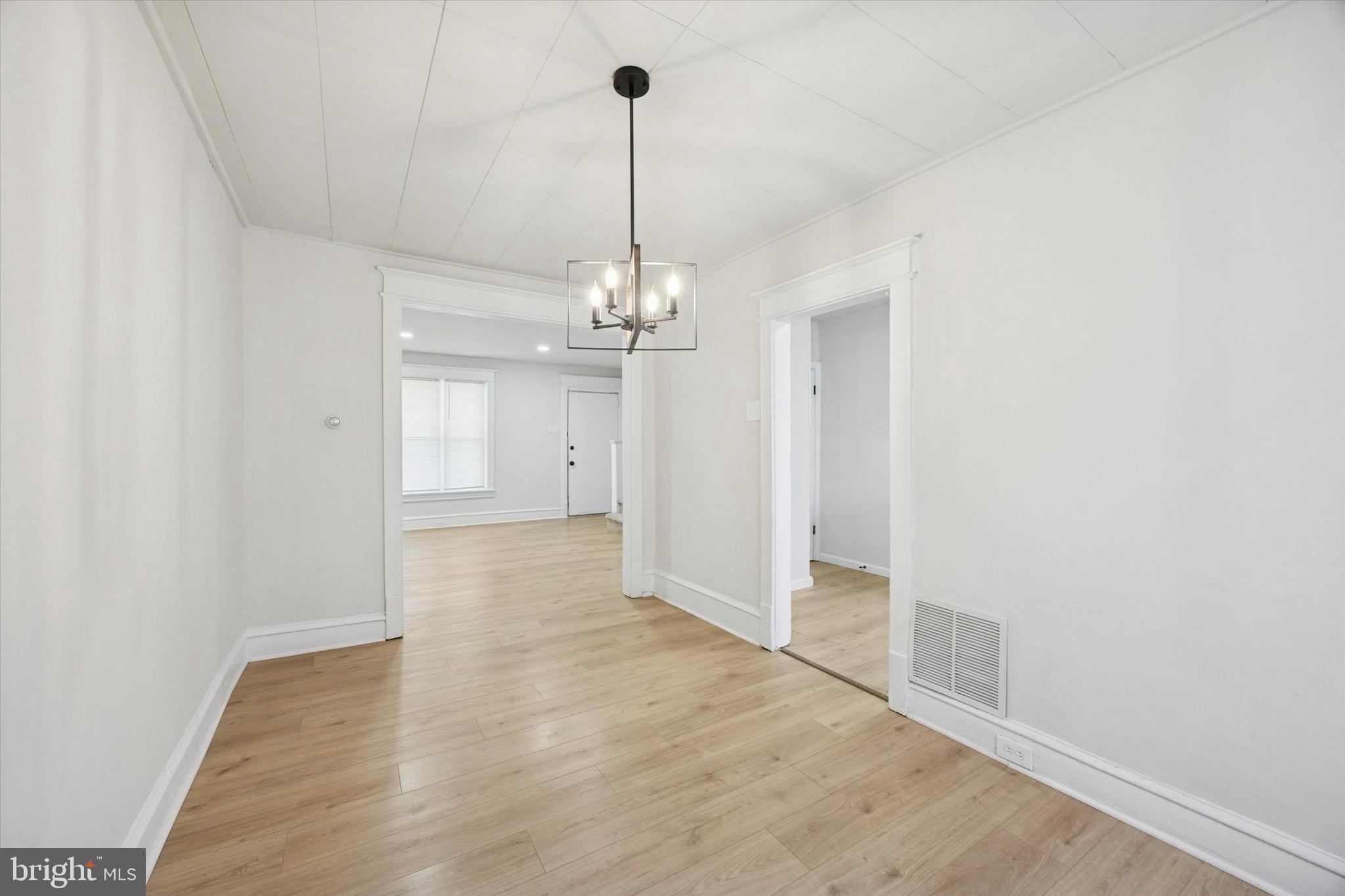 2537 South Millick Street Philadelphia, PA 19142 - Photo 6 of 15 a view of a hallway with wooden floor and a chandelier