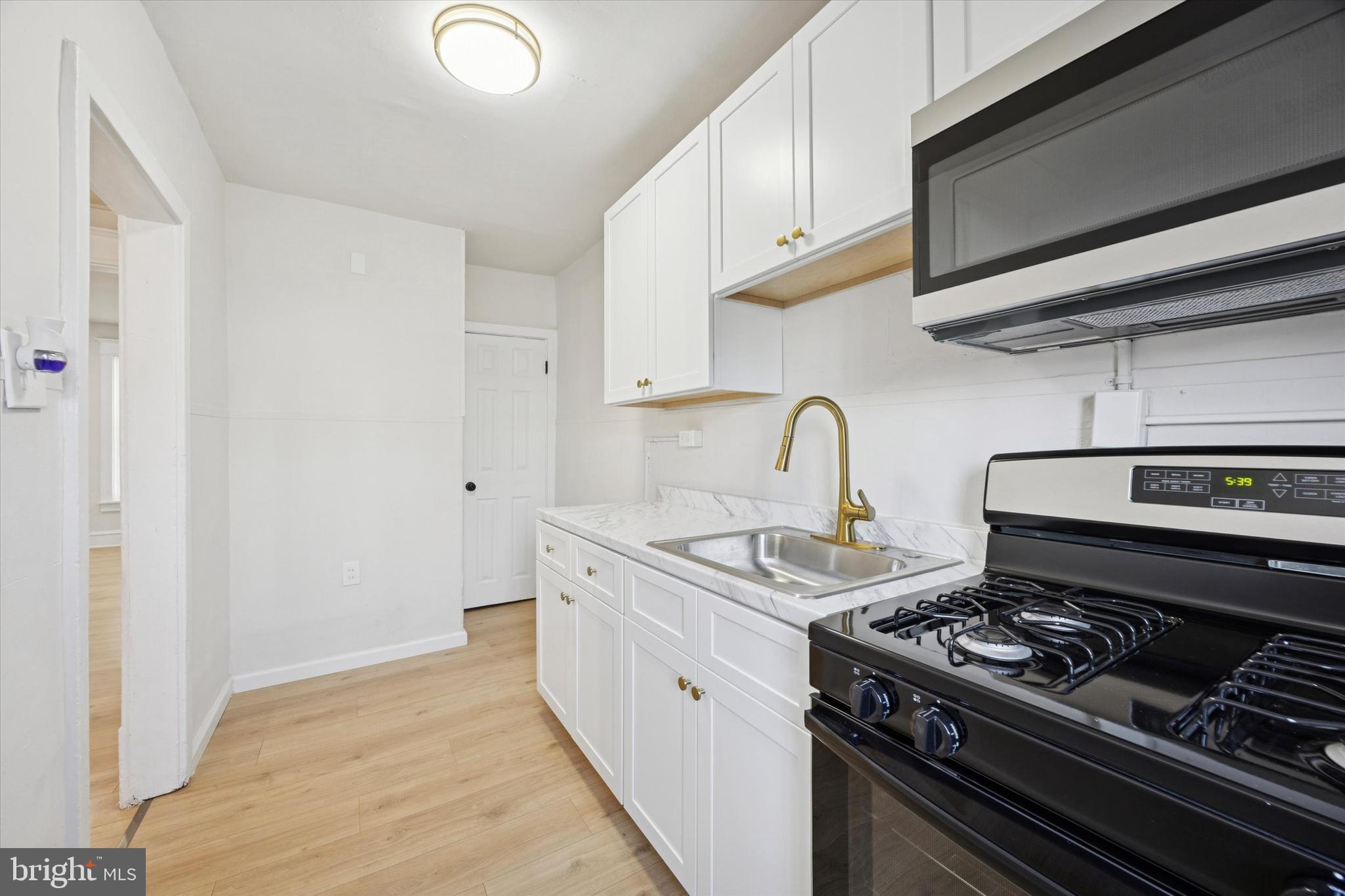 2537 South Millick Street Philadelphia, PA 19142 - Photo 8 of 15 a kitchen with a stove and a sink