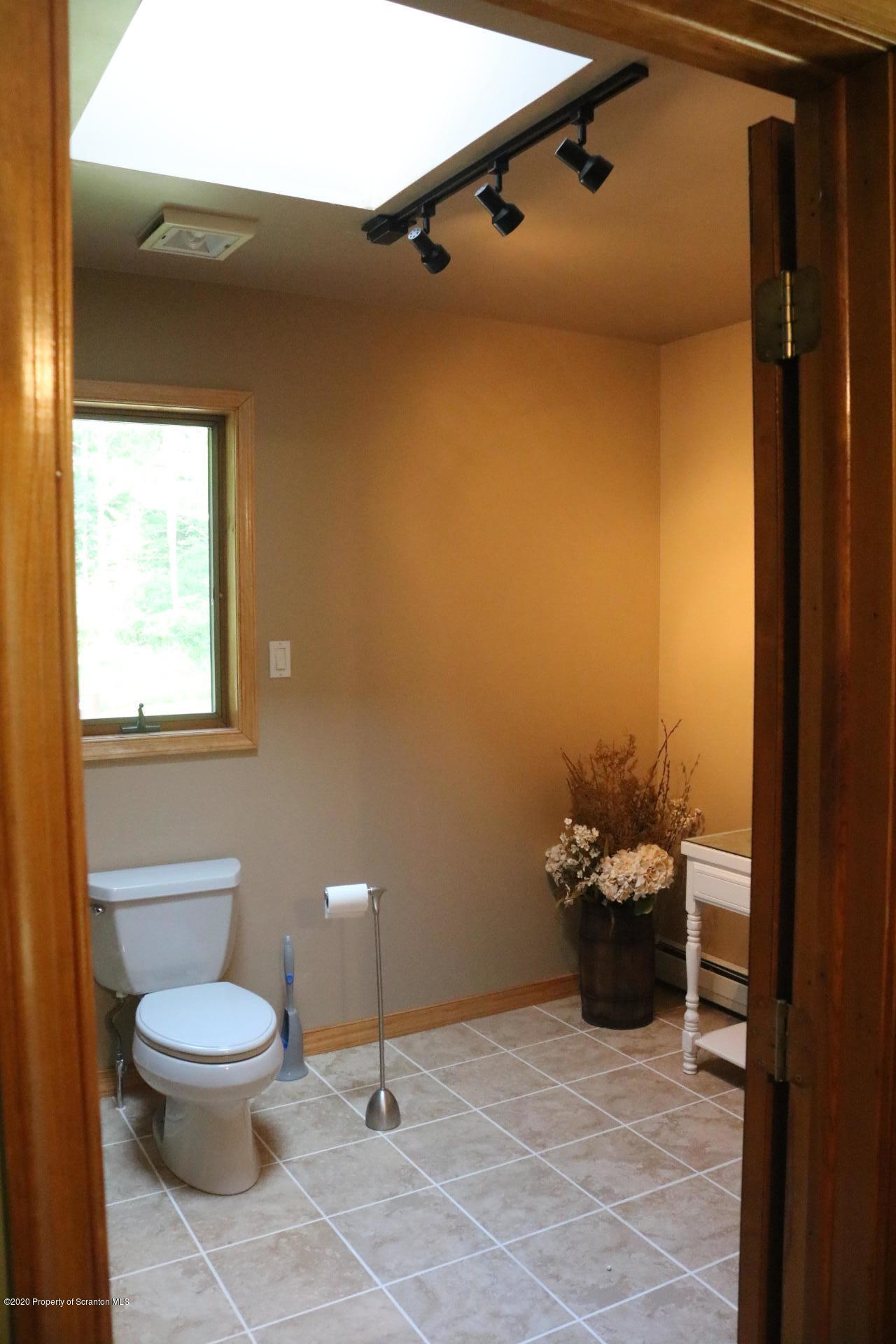871 Swamp Road Hunlock Creek, PA 18621 - Photo 40 of 64 a bathroom with a toilet a sink and mirror