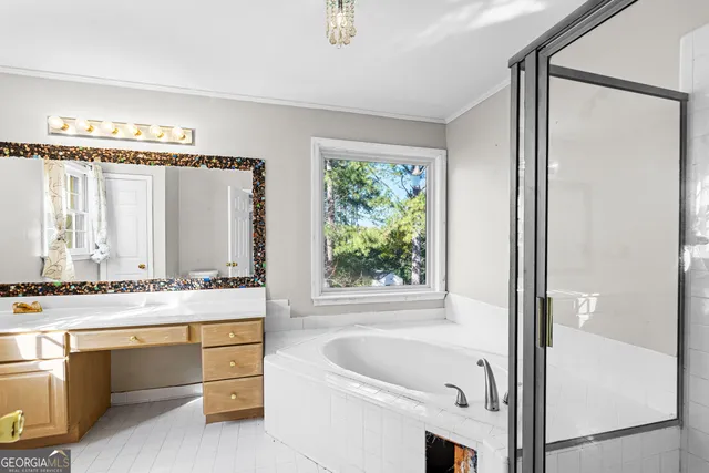 a bathroom with a tub sink and mirror