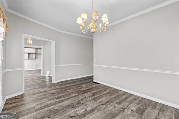 a view of an empty room with a ceiling fan