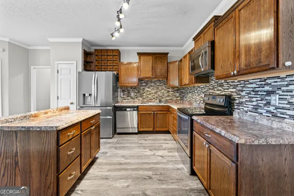 a kitchen with a stove top oven sink and cabinets