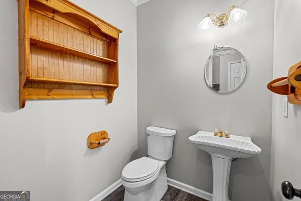 an empty room with windows and chandelier fan