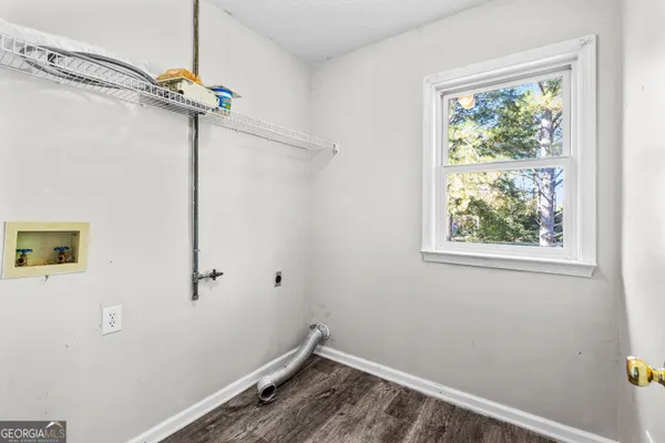 a view of a hallway with wooden floor and entryway