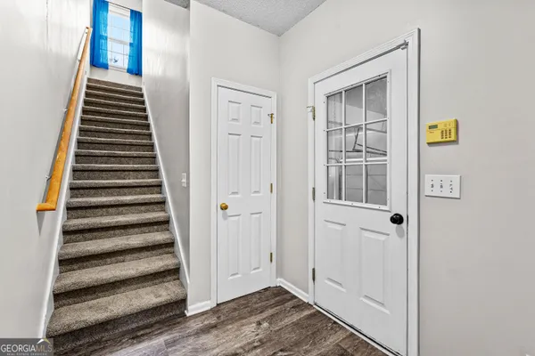 a view of an entryway with wooden floor and windows
