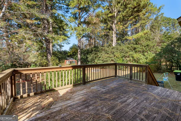 a balcony with wooden floor and fence