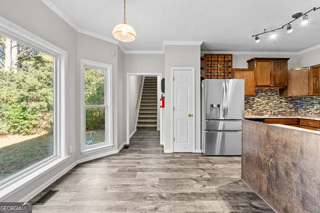 a view of a kitchen with a refrigerator cabinets and a wooden floor