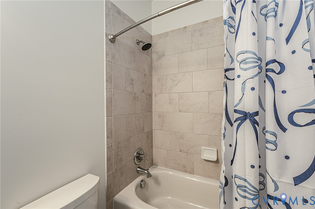 2018 Valentine Road Henrico, VA 23228 - Photo 29 of 65 a bathroom with a bathtub a toilet and a shower