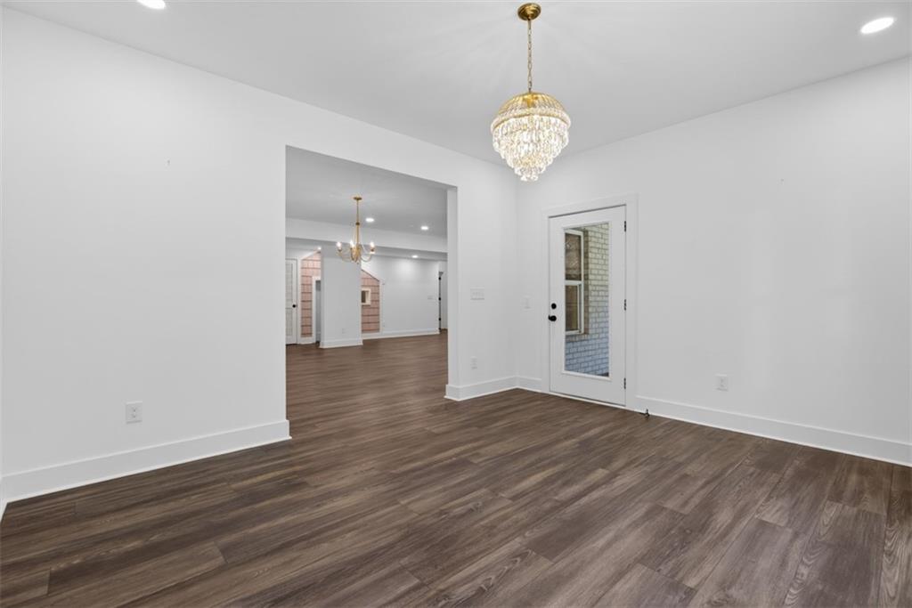 3528 North Bogan Road Buford, GA 30519 - Photo 64 of 79 a view of an empty room with wooden floor and a window