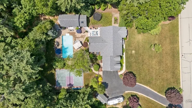 an aerial view of a house with a yard